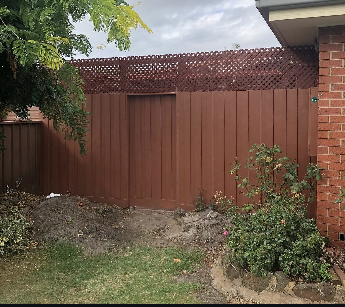 New timber fence and gate with vertical boards and a lattice top