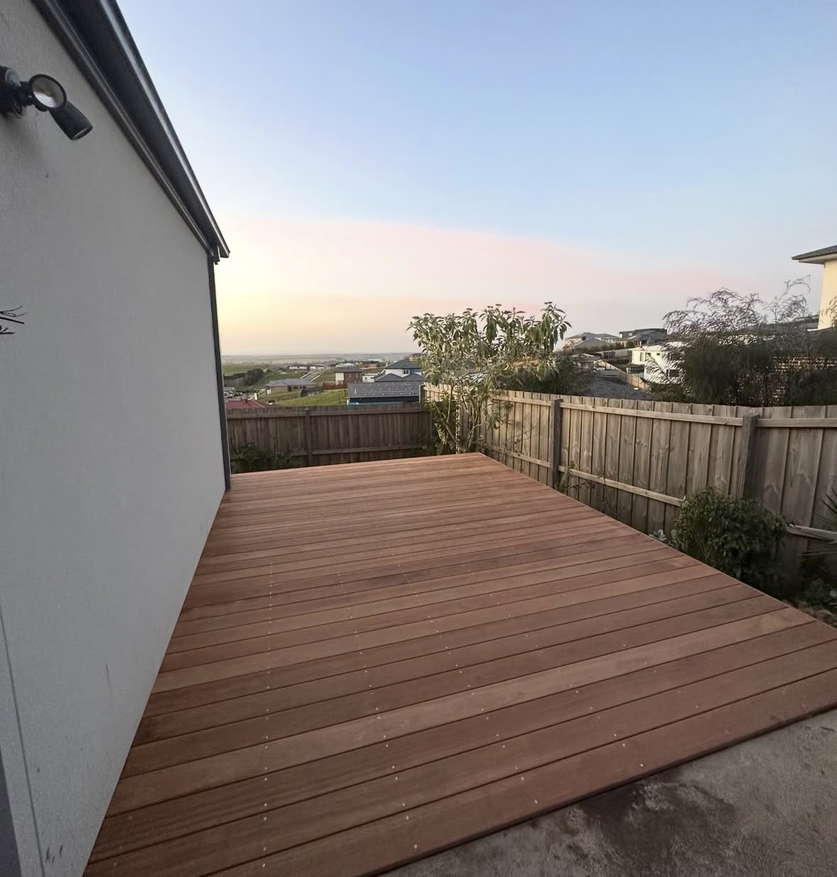 Merbau deck bordered by a timber fence in Geelong